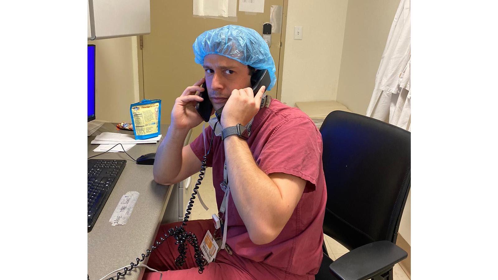 Resident in scrubs using two phones at once