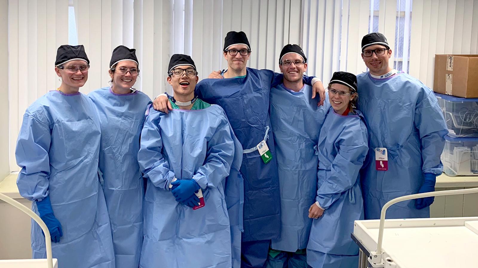 Group of orthopedic surgery residents wearing surgical gowns.
