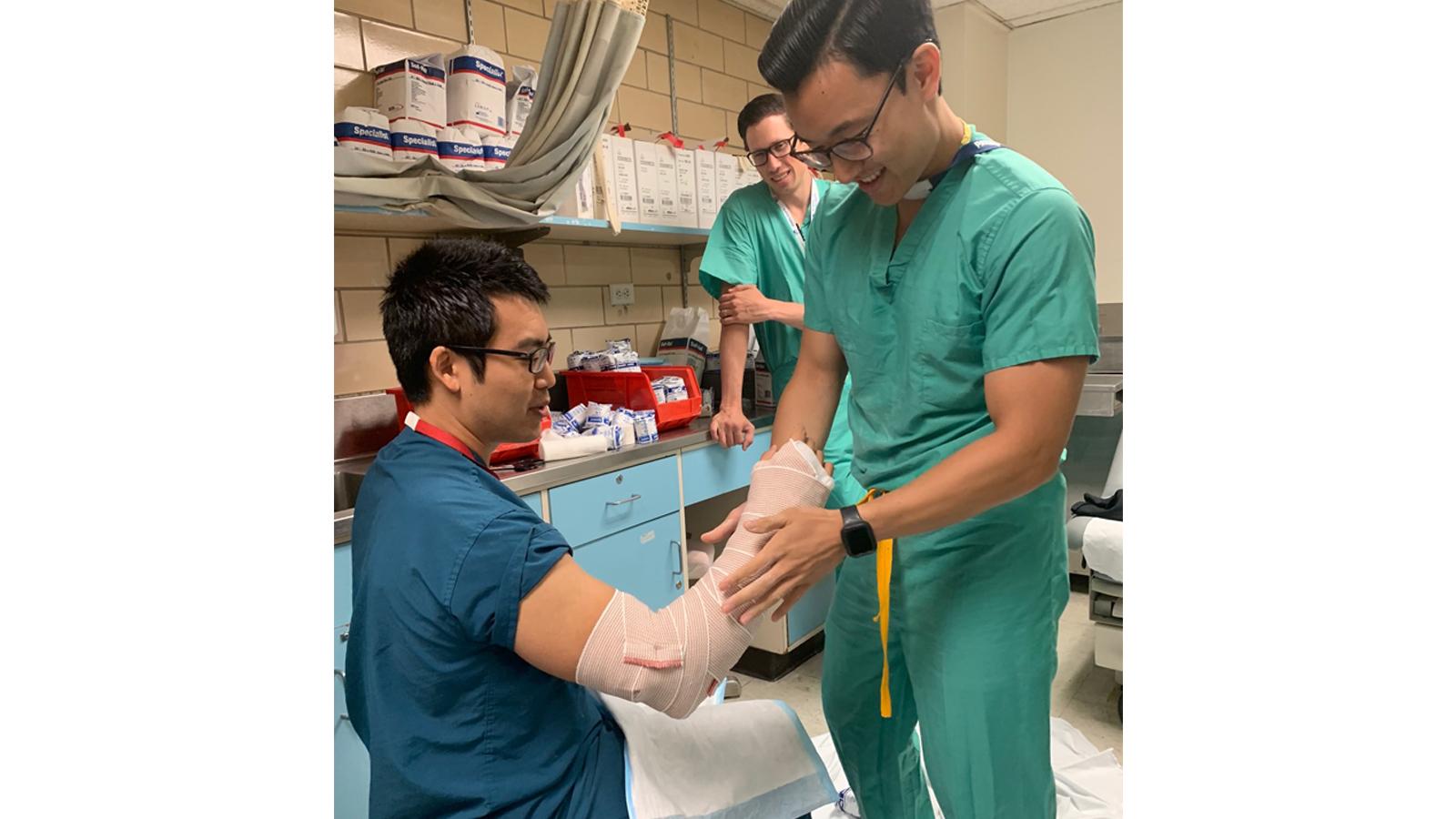 Orthopedic surgery residents practicing casting techniques