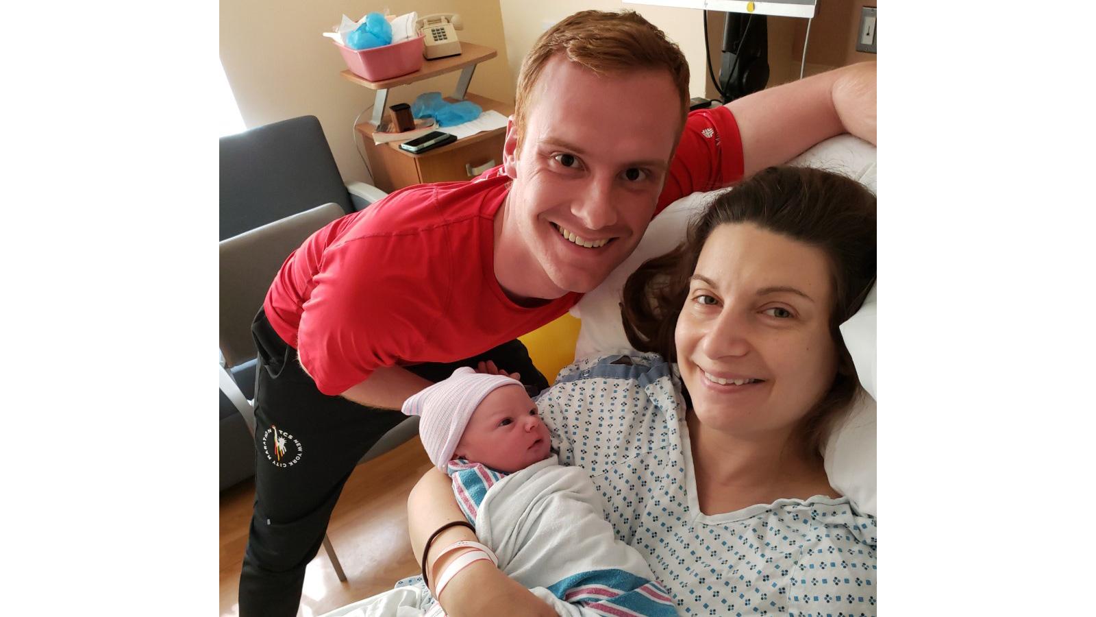 Couple with newborn in hospital.