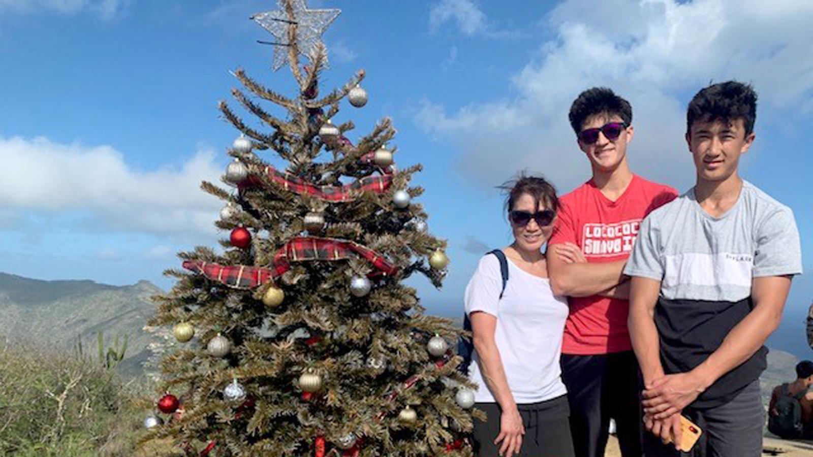 Angela A. Wang, MD with her sons and a Christmas tree