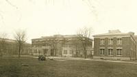 The brick NYOH White Plains buildings with a group of children standing in front.