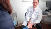 Dr. Justin Greisberg examines a patient's ankle