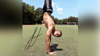 Fit male athlete performing a hand-stand